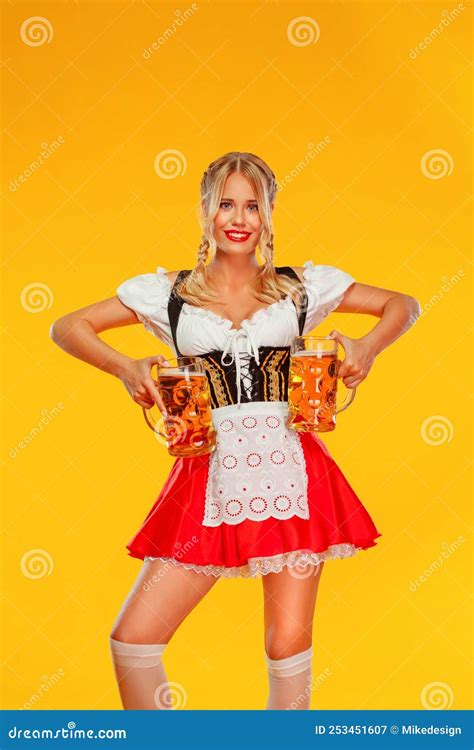 Young Oktoberfest Girl Waitress Wearing A Traditional Bavarian Or German Dirndl Woman Serving