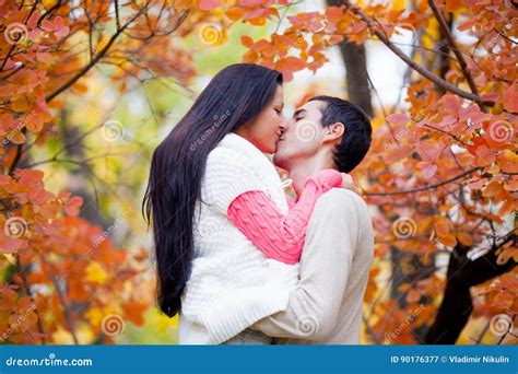 Photo Of Cute Couple Kissing On The Wonderful Autumn Park Background Stock Image Image Of