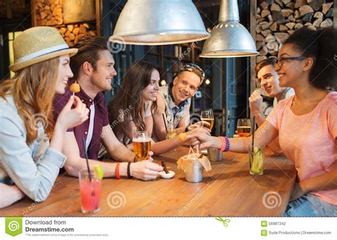 Happy Friends With Drinks Talking At Bar Or Pub Stock Photo Image
