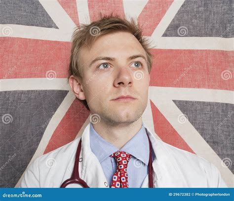 Caucasian Doctor Looking Away With British Flag In Background Stock