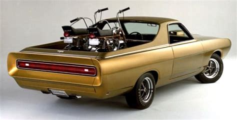 A Gold Muscle Car With An Engine In The Back And Two Bikes On Top Of It