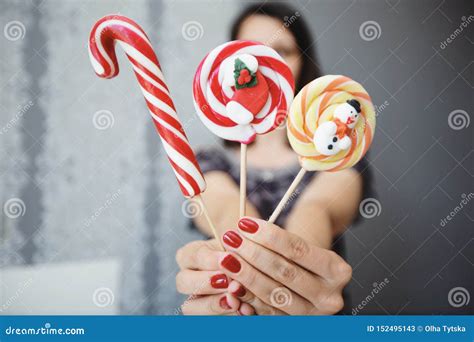 The Girl Holds Colored Christmas Candies In Her Hands Sweets In The