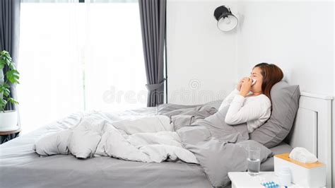 Young Asian Woman With Seasonal Infections Cold Blowing Her Nose And