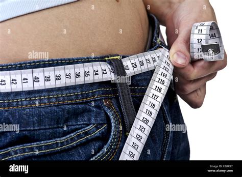 Midsection Of A Young Woman Who Has Wrapped A Measuring Tape Around Her