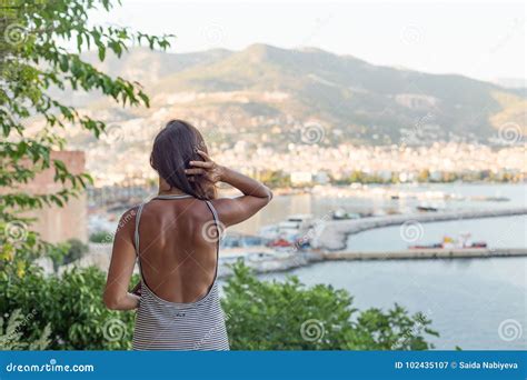 Backview Portrait Of Fit Woman Enjoying The View Of The Bay Of A Stock