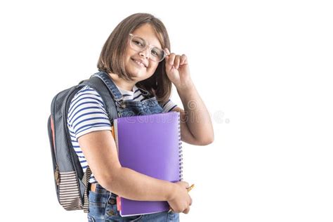 Schoolgirl Fixes Her Glasses As She Holds Her Study Books And Wears