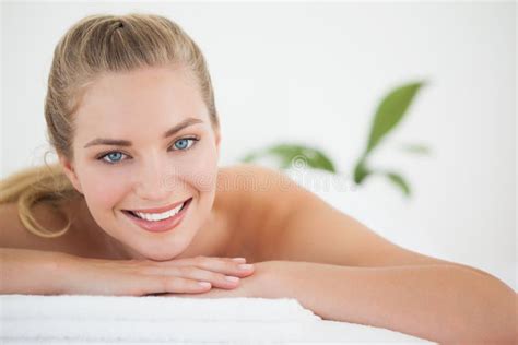 Beautiful Blonde Relaxing On Massage Table Smiling At Camera Stock