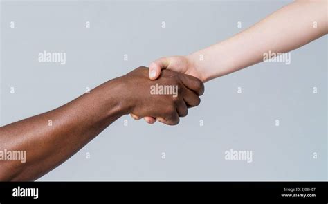 Black And White Human Hands African And Caucasian Hands Giving A