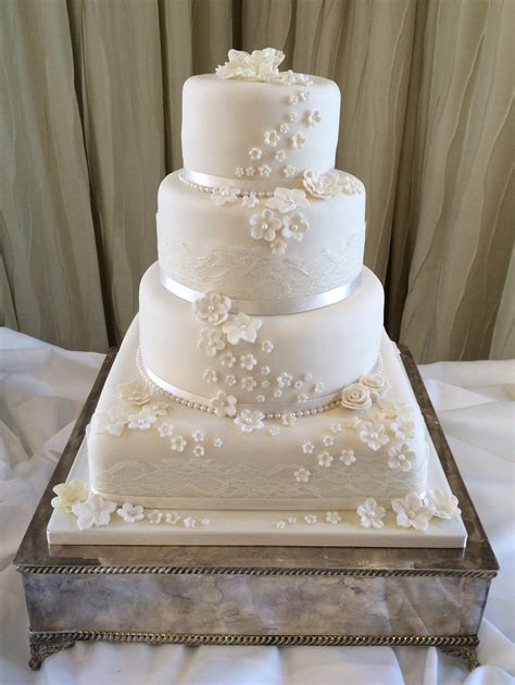 4 Tier Ivory Wedding Cake With A Lace And Blossom Detail Wedding