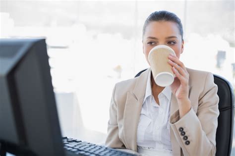 Premium Photo Relaxed Sophisticated Businesswoman Drinking Coffee