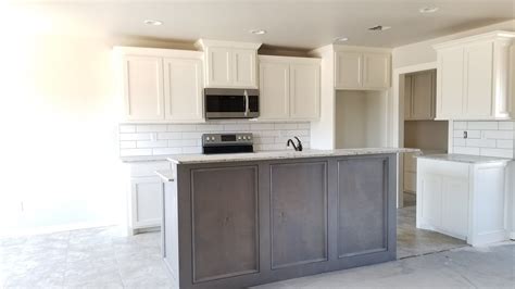 White and gray kitchen features a light gray glass backsplash complementing white flat front cabinets topped with a gray quartz countertop. Two-tone kitchen cabinets, also love the interesting grey ...