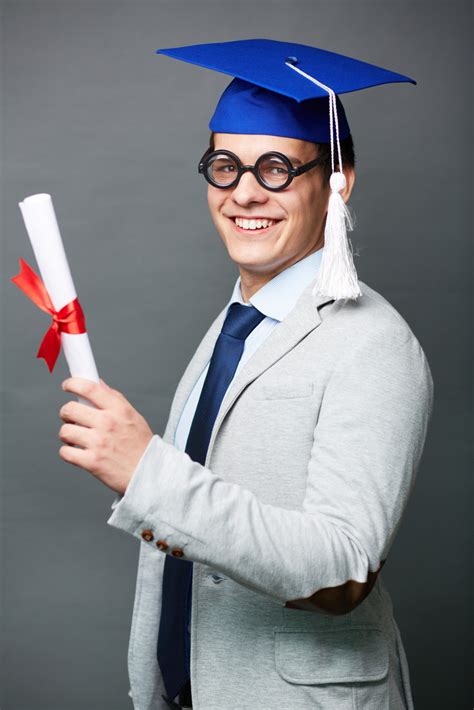 Vertical Isolated Portrait Of A Young Man Wearing A Graduation Cap And