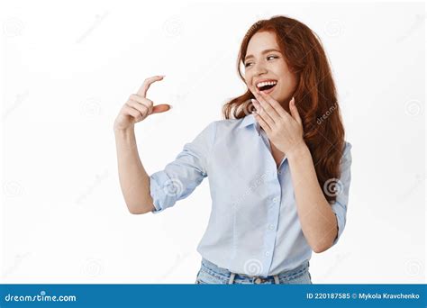 Happy Female Model Looking At Small Tiny Thing Showing Little Hand