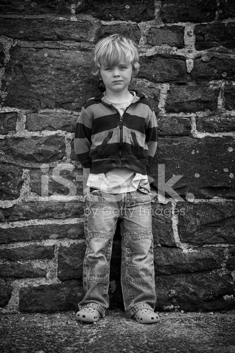 Moody Child Standing By Wall Stock Photo Royalty Free Freeimages