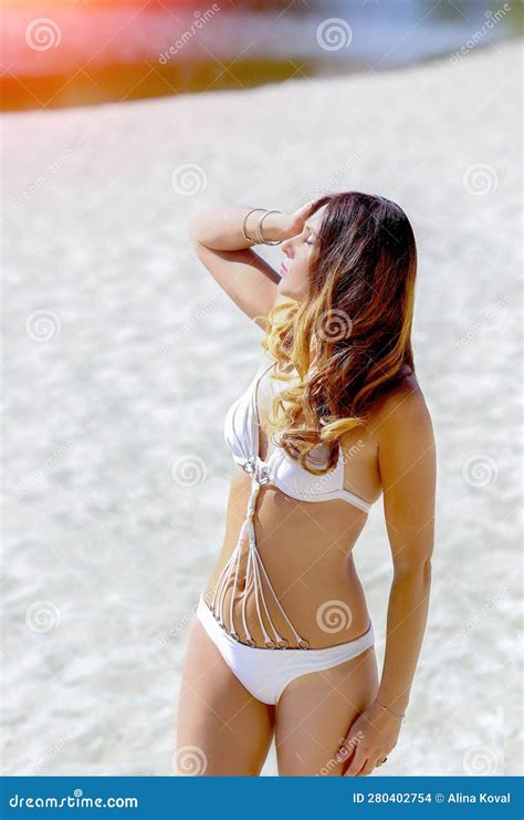 A Beautiful Caucasian Girl In A White Bikini On The Beach Looks Into The Distance Beautiful