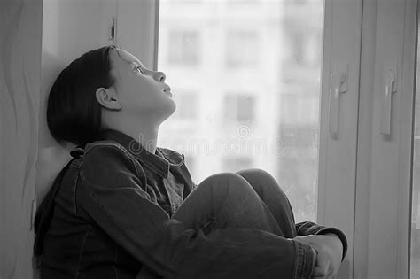 Sad Girl Sitting On A Window Sill In Depression Stock Image Image Of