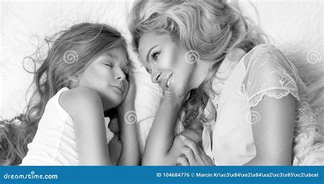 Portrait Of The Beautiful Blonde Woman Mother And Daughter On The Beautiful Face And Amazing