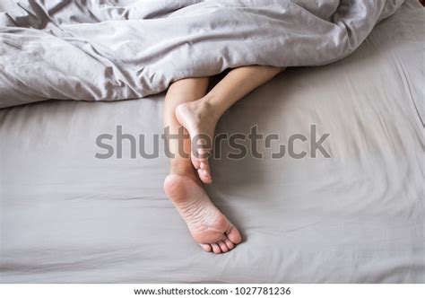 Barefoot Leg Under Blanket On Bed Stock Photo Edit Now 1027781236