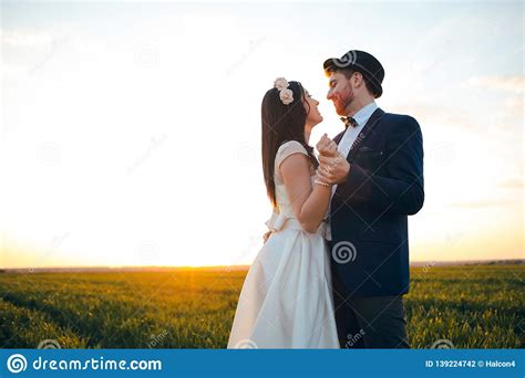 Romantic Feelings In The Field At Sunset The Groom Looks At The Bride