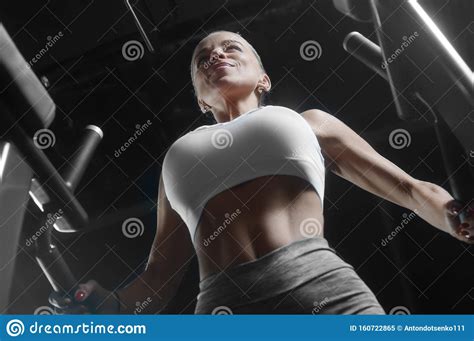 Pretty Caucasian Fitness Woman Pumping Up Muscles Workout Fitness And Bodybuilding Concept Gym