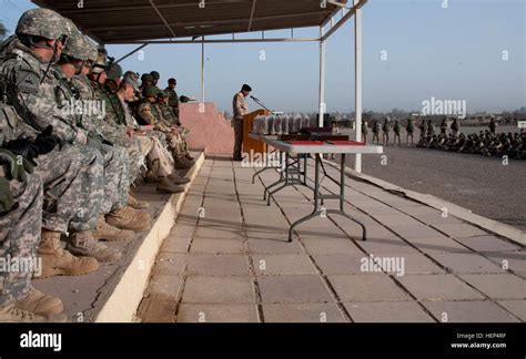 Us And Iraqi Army Leaders Left And Graduating Iraqi Army Trainees Seated At Right Listen