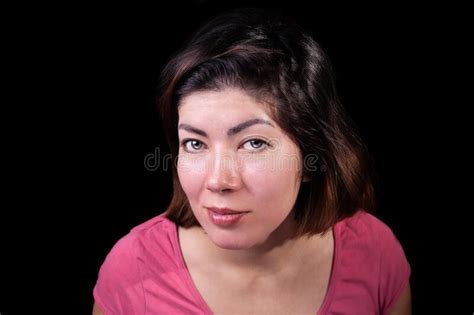 Portrait Of A Beautiful Brunette Girl With Makeup In A Pink T Shirt On An Isolated Black