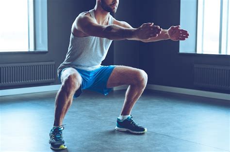 Premium Photo Deep Squat Part Of Young Man In Sportswear Doing Squat