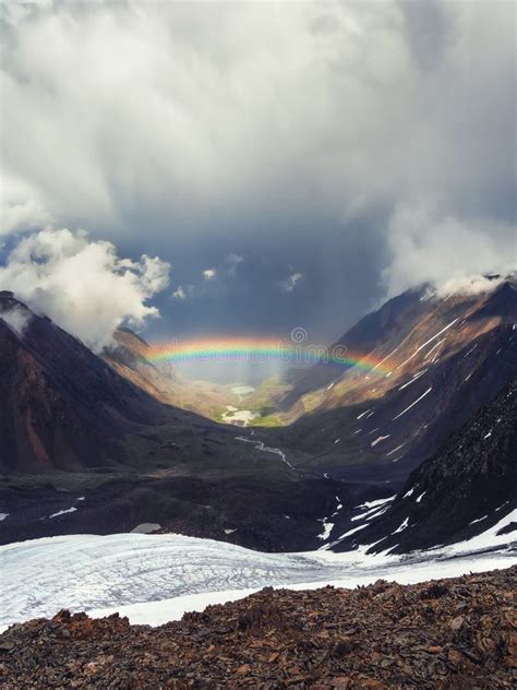 Rainbow Over A Mountain Valley Gloomy Scenery With Bright Rainbow