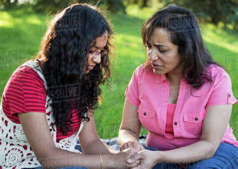 Mother And Daughter Praying Together In A Park Edmonton Alberta