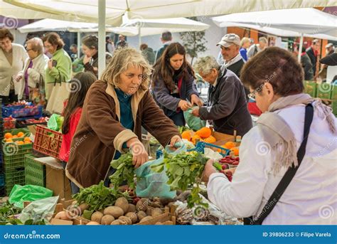 People Selling And Buying In A Traditional Farmers Market In Portugal