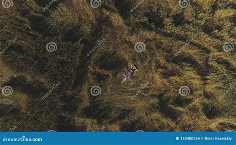 Aerial Attractive Girl In A Rustic Dress Lies In The Hayloft Young