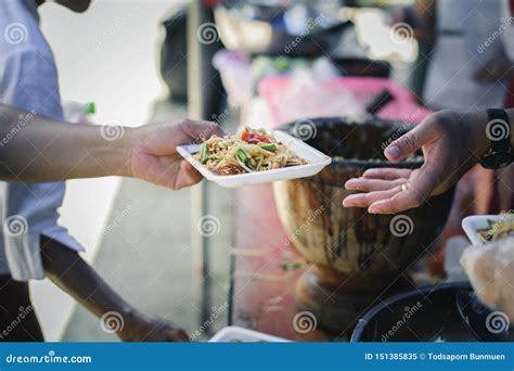 Volunteers Giving Food To Poor People In Desperate Need The Concept Of Food Sharing Help Solve