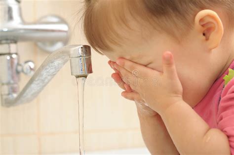 2 wash your newborn's eye area. Little girl washing face stock photo. Image of child ...