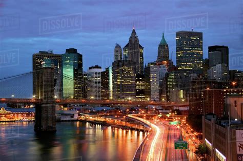 New York City Skyline And Brooklyn Bridge At Night Stock