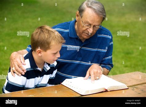 Grandfather And Grandson Reading The Bible Stock Photo 15033947 Alamy