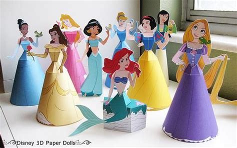 Some Paper Dolls That Are Sitting On A Table Next To Each Other And One