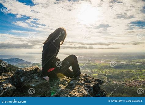 girl sitting on the edge of a cliff stock image image of brave horizon 139004049
