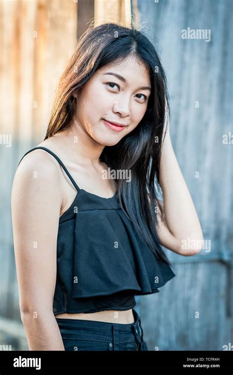 a beautiful thai girl poses at the famous tourist landmark pae gate chiang mai thailand stock