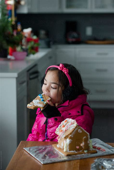 Girl Eating Gingerbread House By Stocksy Contributor Ronnie Comeau Stocksy