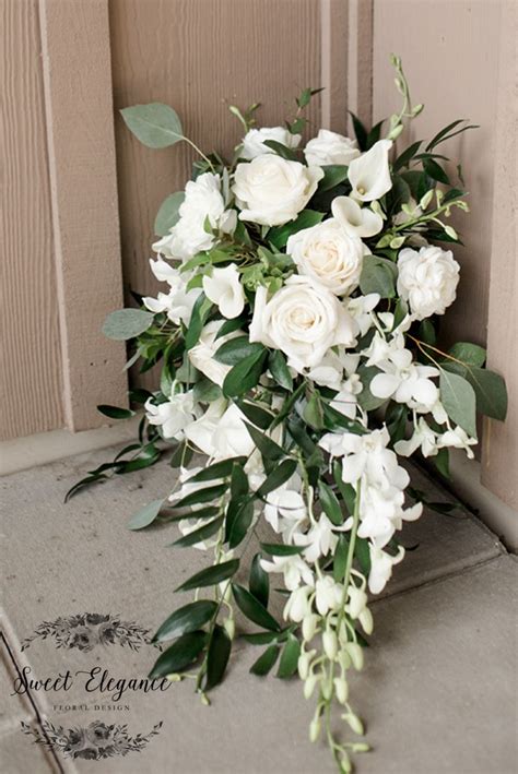 Brides Cascade Bouquet Made Of White Roses Calla Lilies Orchids