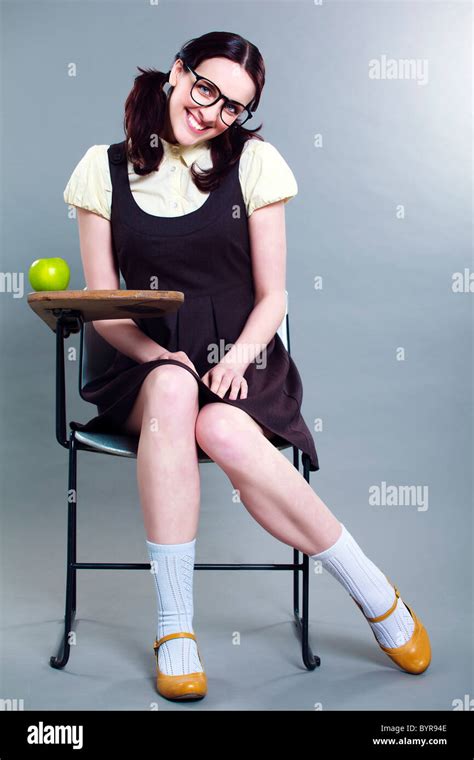 Coy Geeky School Girl Full Length Smiling At Her Desk Stock Photo Alamy