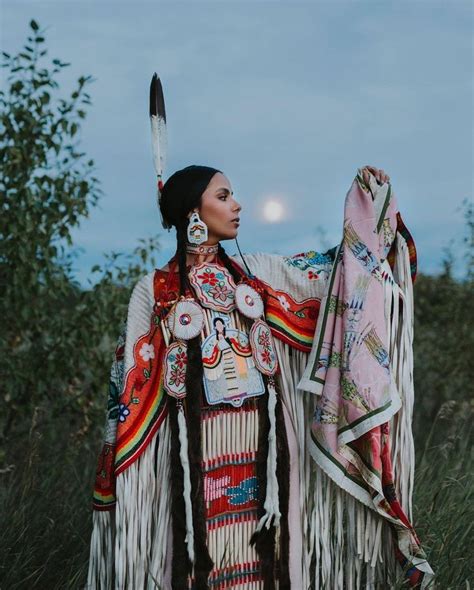 A Native American Woman Dressed In Traditional Clothing