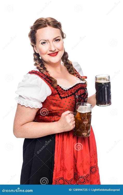 happy oktoberfest waitress in traditional bavarian dress holding mugs with light and dark beer
