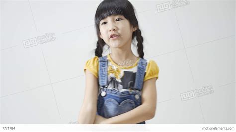 Little Asian Girl Singing And Dancing On White Background Stock Video