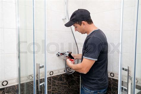 Plumber Repairing Faucet In Shower Stall Stock Image Colourbox