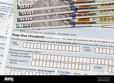 Student loan application and one-hundred dollar bills. Concept of