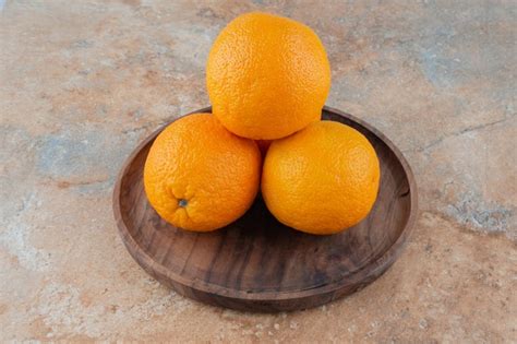 Free Photo Fresh Sour Oranges On Wooden Plate