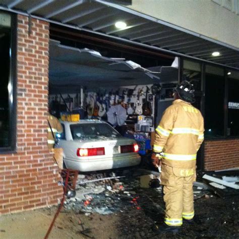 Pictures Car Crashes Into Building When Driver Reaches To Get Phone