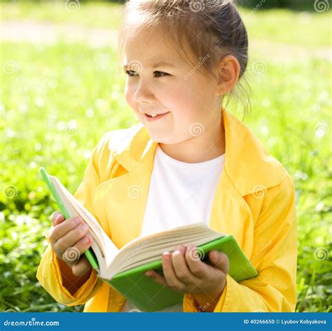 Little Girl Is Reading A Book Outdoors Stock Photo Image Of Caucasian