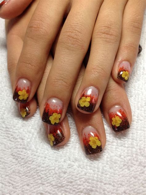A Womans Nails With Flowers Painted On Them